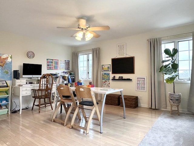 dining area with ceiling fan and light wood-type flooring