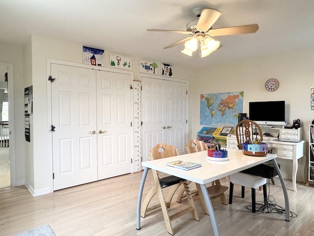 dining area featuring light wood-type flooring and ceiling fan