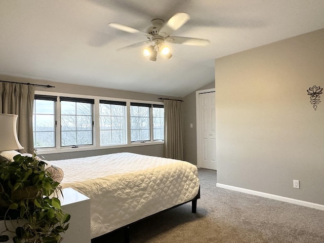 bedroom with multiple windows, ceiling fan, carpet, and vaulted ceiling