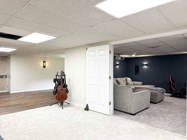 carpeted living room with a paneled ceiling