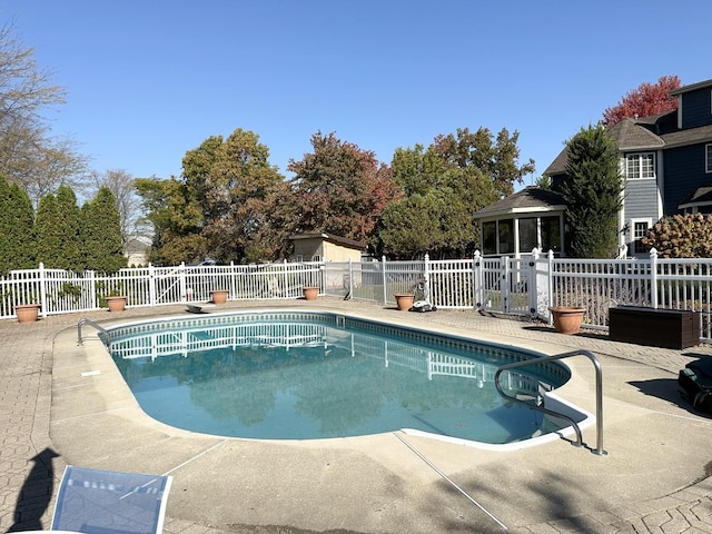 view of pool with a patio area and a sunroom