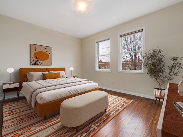 bedroom with dark wood-type flooring