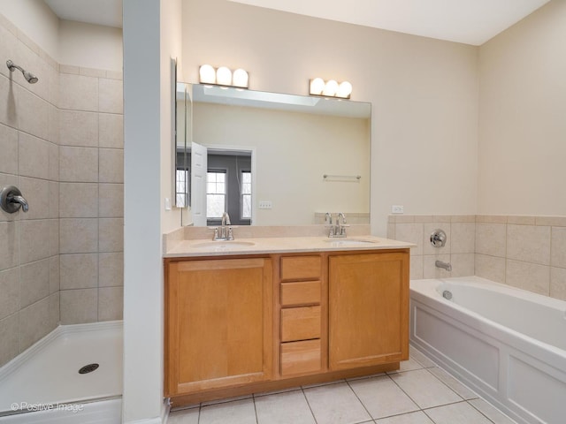 bathroom featuring shower with separate bathtub, vanity, and tile patterned floors