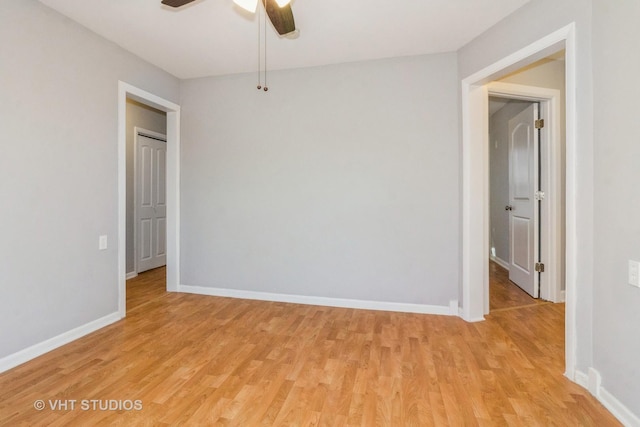 empty room with ceiling fan and light hardwood / wood-style floors