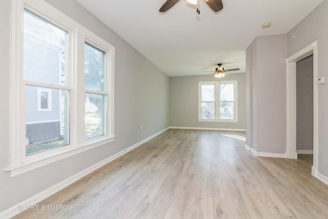 unfurnished room with ceiling fan, light hardwood / wood-style flooring, and a healthy amount of sunlight