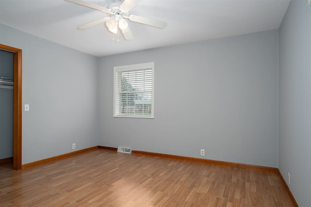 unfurnished bedroom with ceiling fan, light wood-type flooring, and a closet