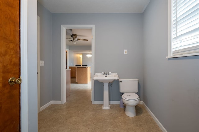 bathroom featuring ceiling fan and toilet