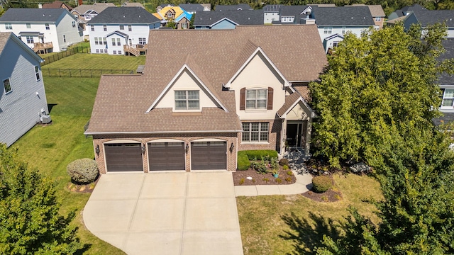 view of front of property with a front yard and a garage