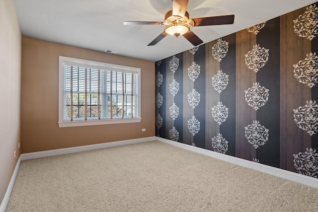 empty room with carpet and ceiling fan