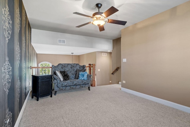 living area featuring carpet and ceiling fan