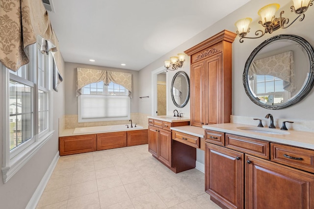 bathroom with tile patterned floors, a bathtub, vanity, and a chandelier