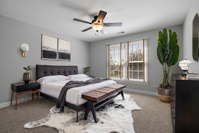 bedroom featuring ceiling fan and light carpet