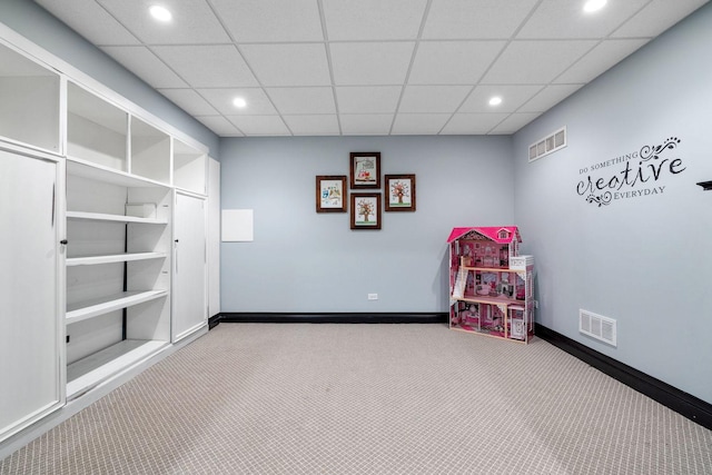 playroom featuring a drop ceiling and light colored carpet