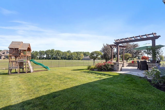 view of yard with a pergola and a playground