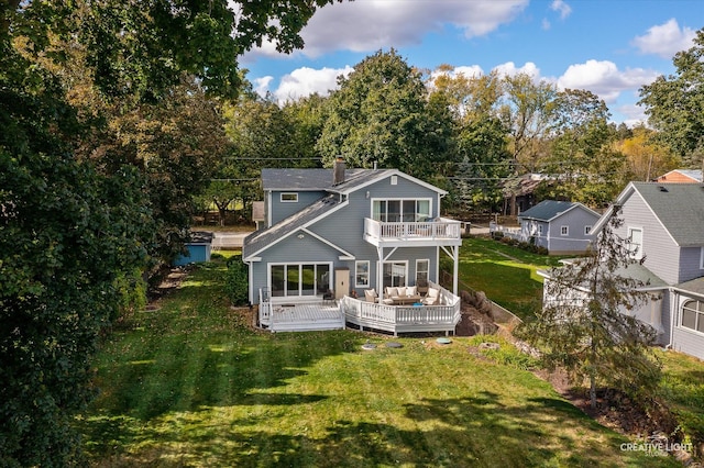 back of house with a lawn, outdoor lounge area, and a balcony