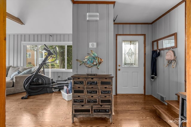 entryway featuring crown molding and hardwood / wood-style floors