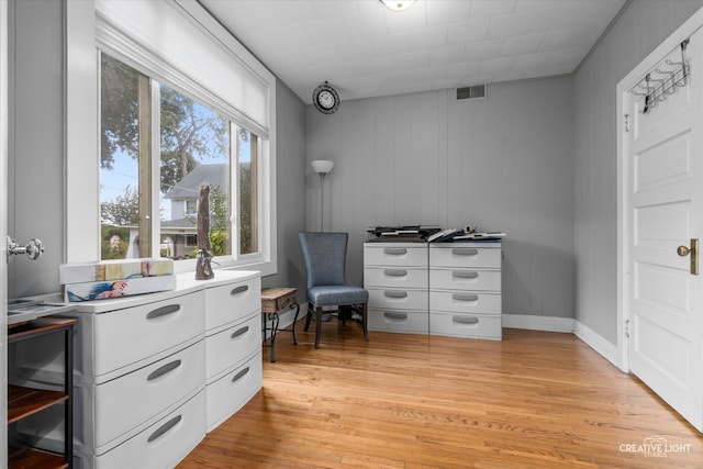 interior space featuring wooden walls and light hardwood / wood-style flooring