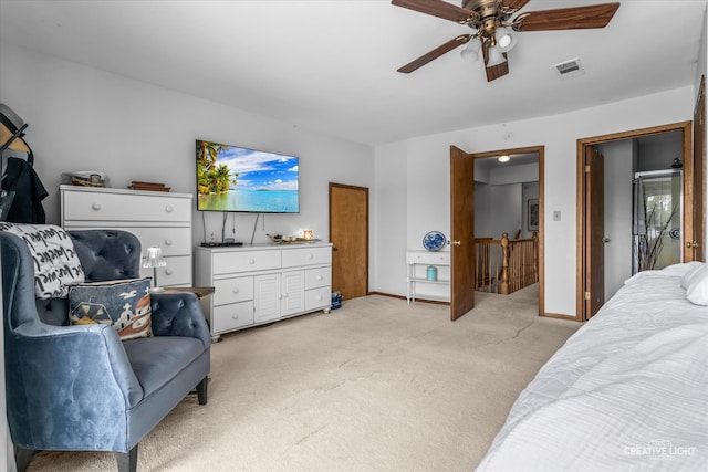 bedroom with ceiling fan and light carpet