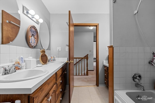 bathroom featuring tile patterned flooring, vanity, and bathing tub / shower combination