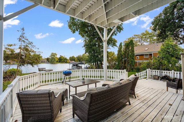 wooden terrace featuring an outdoor living space and a water view