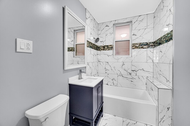 full bathroom with vanity, tiled shower / bath combo, and toilet