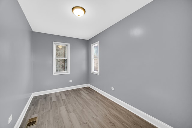 unfurnished room with light wood-type flooring