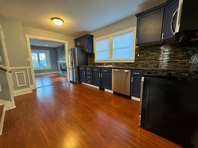 kitchen featuring backsplash, dark hardwood / wood-style floors, sink, and stainless steel appliances