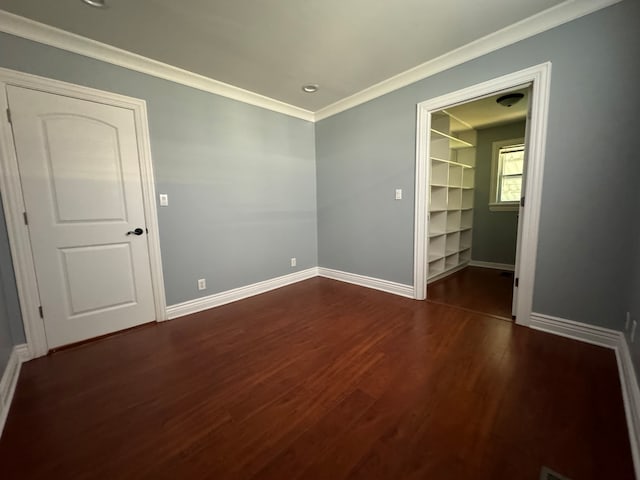 unfurnished room with dark hardwood / wood-style floors and crown molding