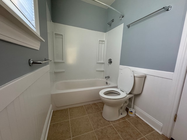 bathroom with bathtub / shower combination, tile patterned floors, and toilet