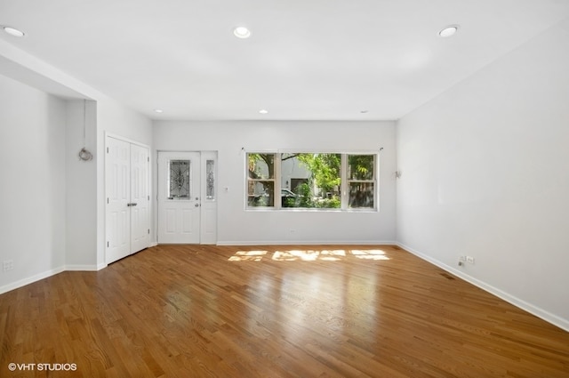 unfurnished room with wood-type flooring