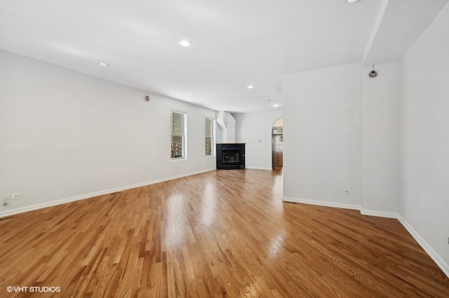 unfurnished living room with hardwood / wood-style flooring and a fireplace