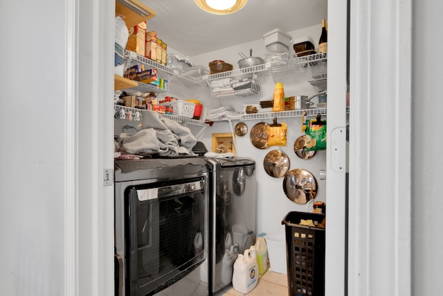 laundry room featuring washer and clothes dryer and light tile patterned flooring