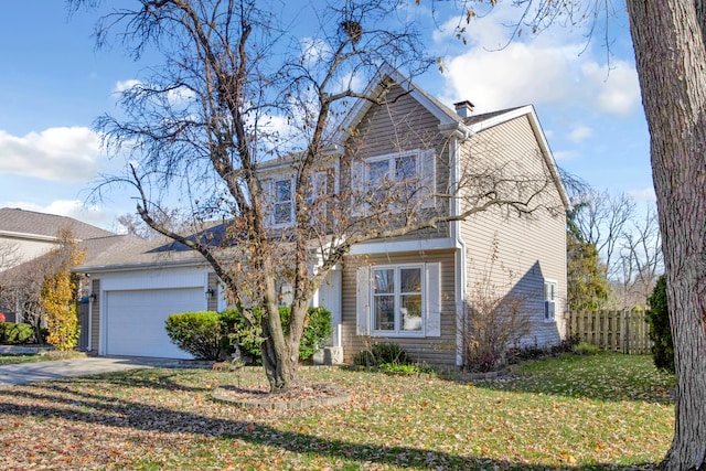 view of front of home featuring a garage and a front lawn