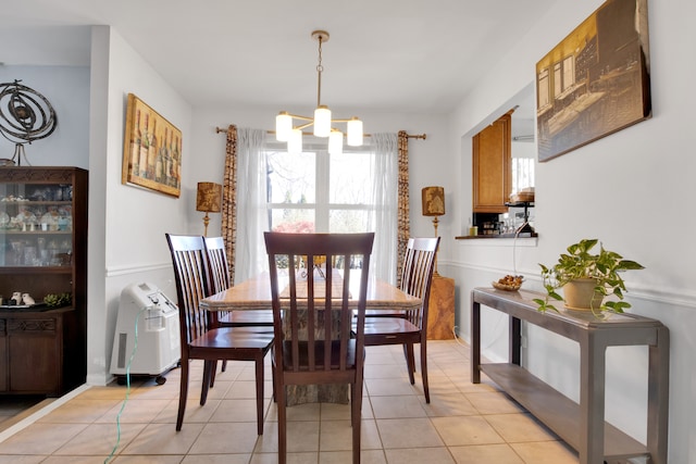 tiled dining room featuring a notable chandelier