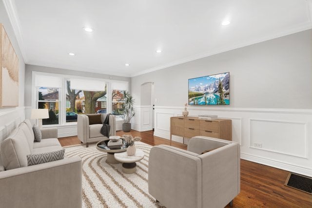 living room featuring crown molding and dark wood-type flooring