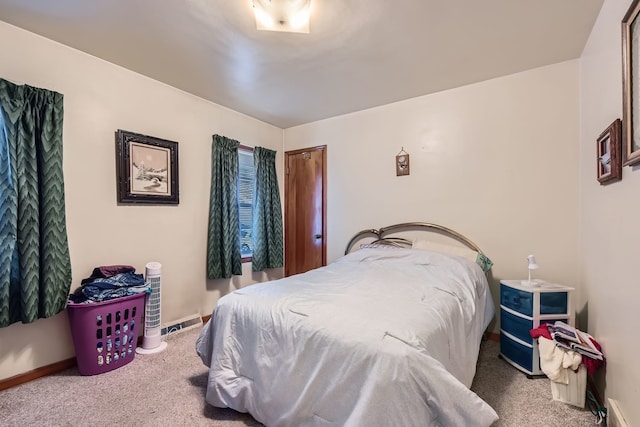 carpeted bedroom with a baseboard heating unit