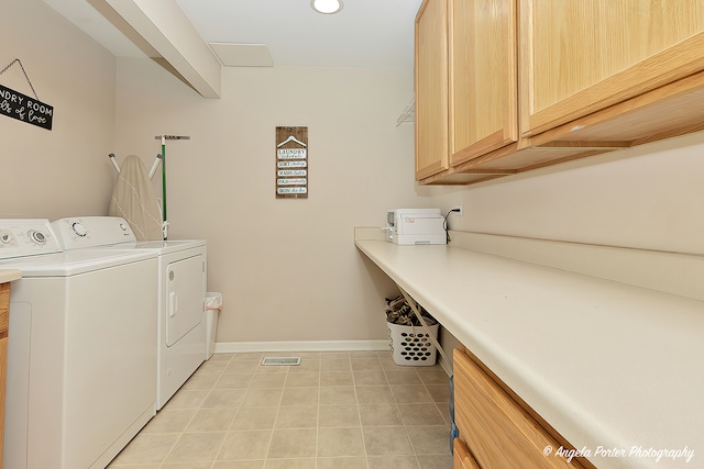 laundry area featuring cabinets, light tile patterned floors, and washing machine and dryer