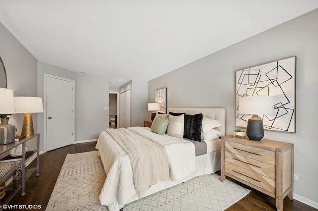 bedroom featuring baseboards and wood finished floors