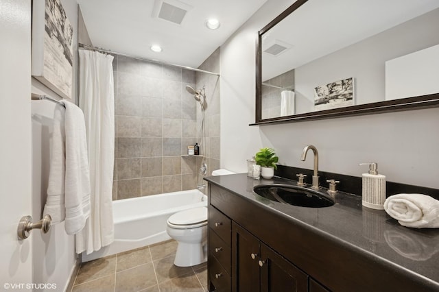 full bathroom featuring vanity, visible vents, toilet, shower / bath combination with curtain, and tile patterned floors