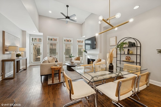 sunroom / solarium with a ceiling fan and a glass covered fireplace