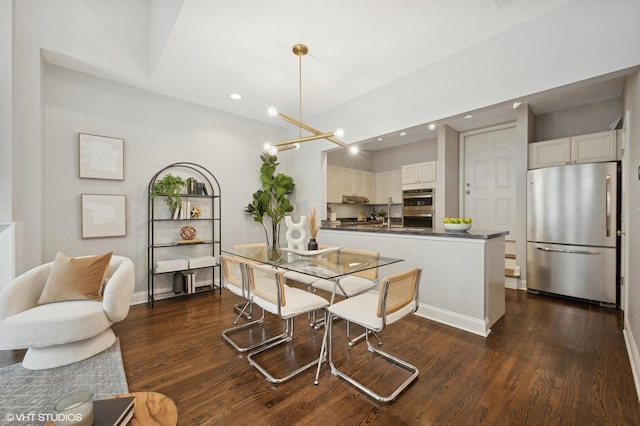 dining room with dark wood-style flooring, baseboards, an inviting chandelier, and recessed lighting