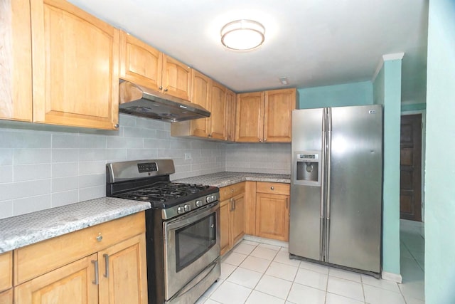 kitchen with light stone countertops, light tile patterned floors, stainless steel appliances, and tasteful backsplash