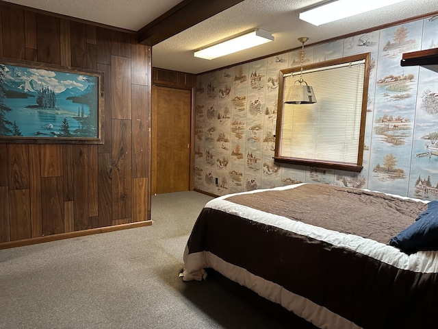 carpeted bedroom with wooden walls and a textured ceiling