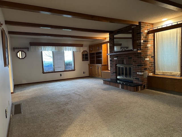 unfurnished living room with carpet, beam ceiling, and a brick fireplace