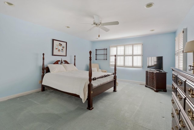 bedroom with ceiling fan and light carpet