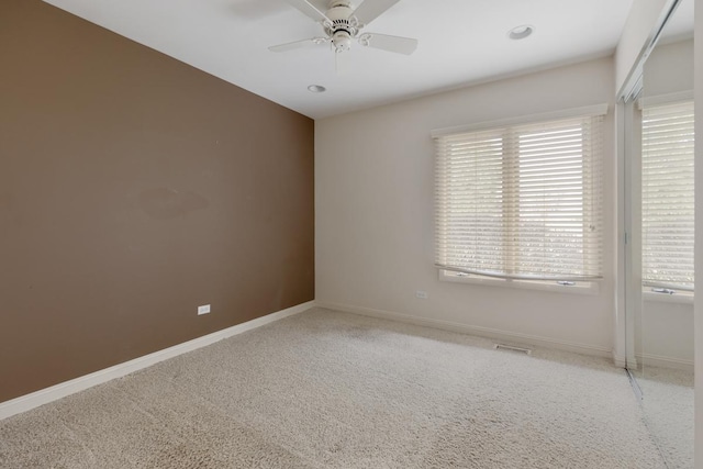 spare room with carpet flooring and ceiling fan