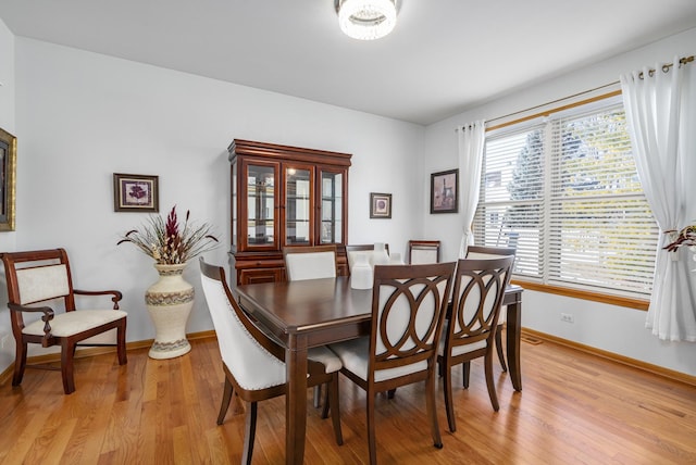 dining space with light hardwood / wood-style flooring