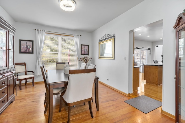 dining space with a wealth of natural light and light wood-type flooring