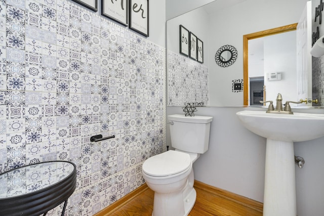 bathroom with hardwood / wood-style floors, sink, and toilet