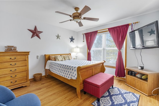 bedroom with light hardwood / wood-style floors and ceiling fan